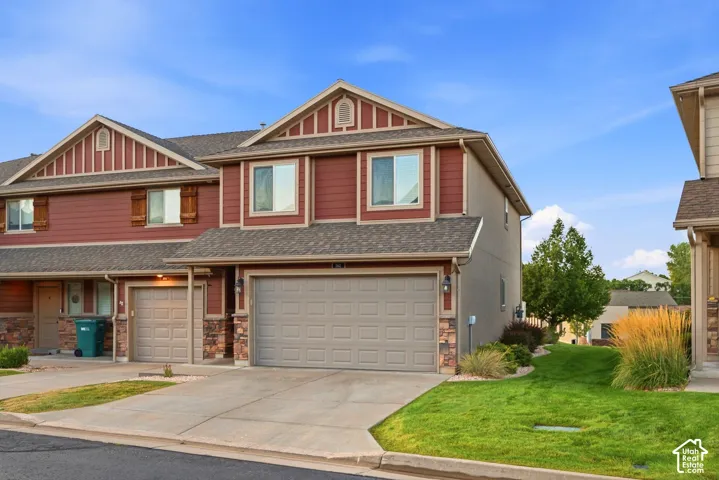 Two-story exterior with red siding and stone accents