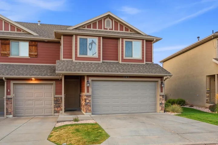 Red siding exterior with stone accents and a gabled roofline