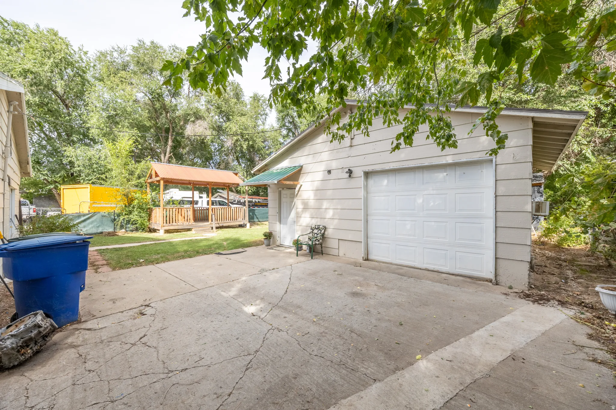 Detached garage featuring a white panel door