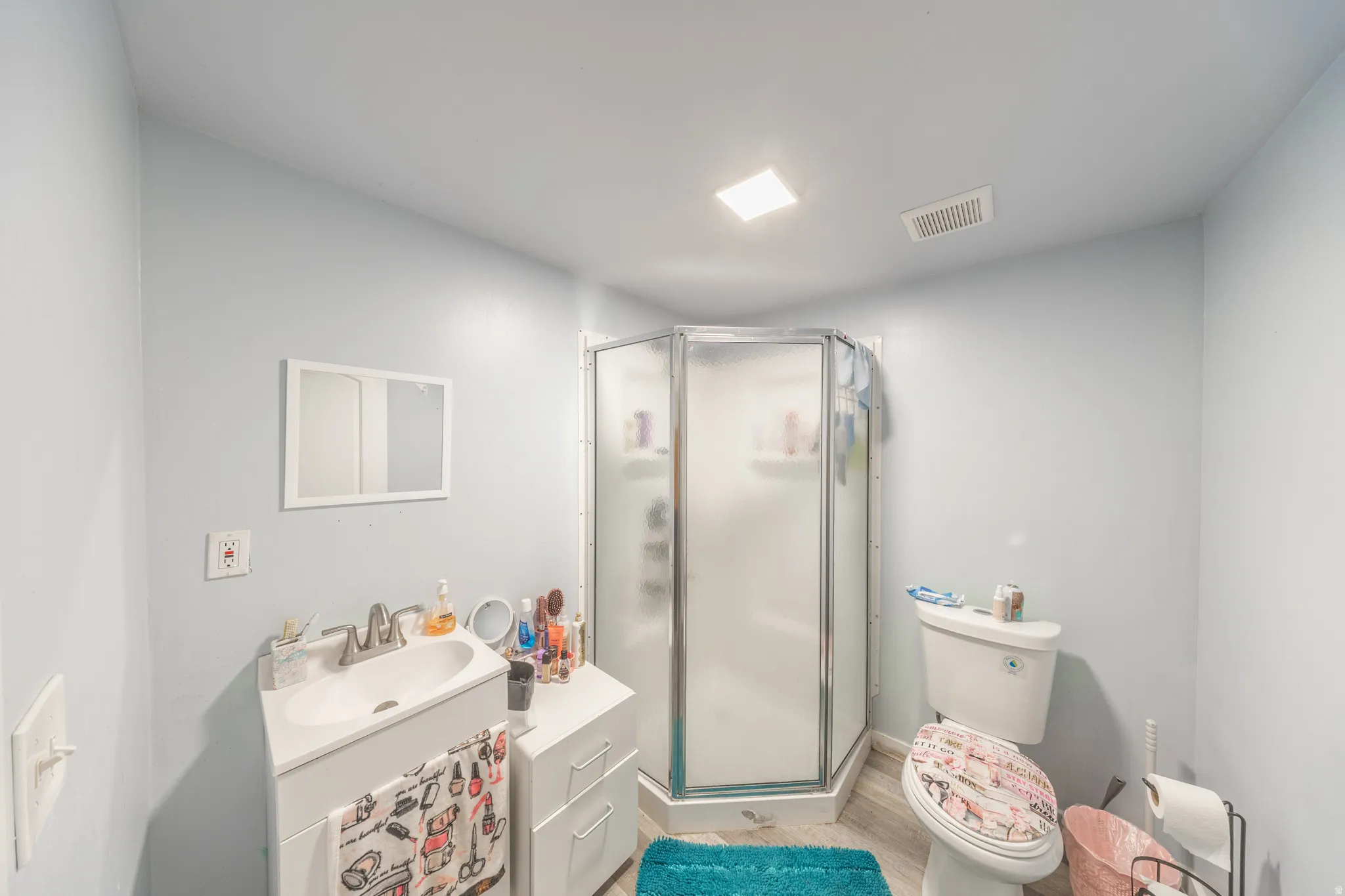 White vanity with integrated sink, chrome faucet, and storage drawers