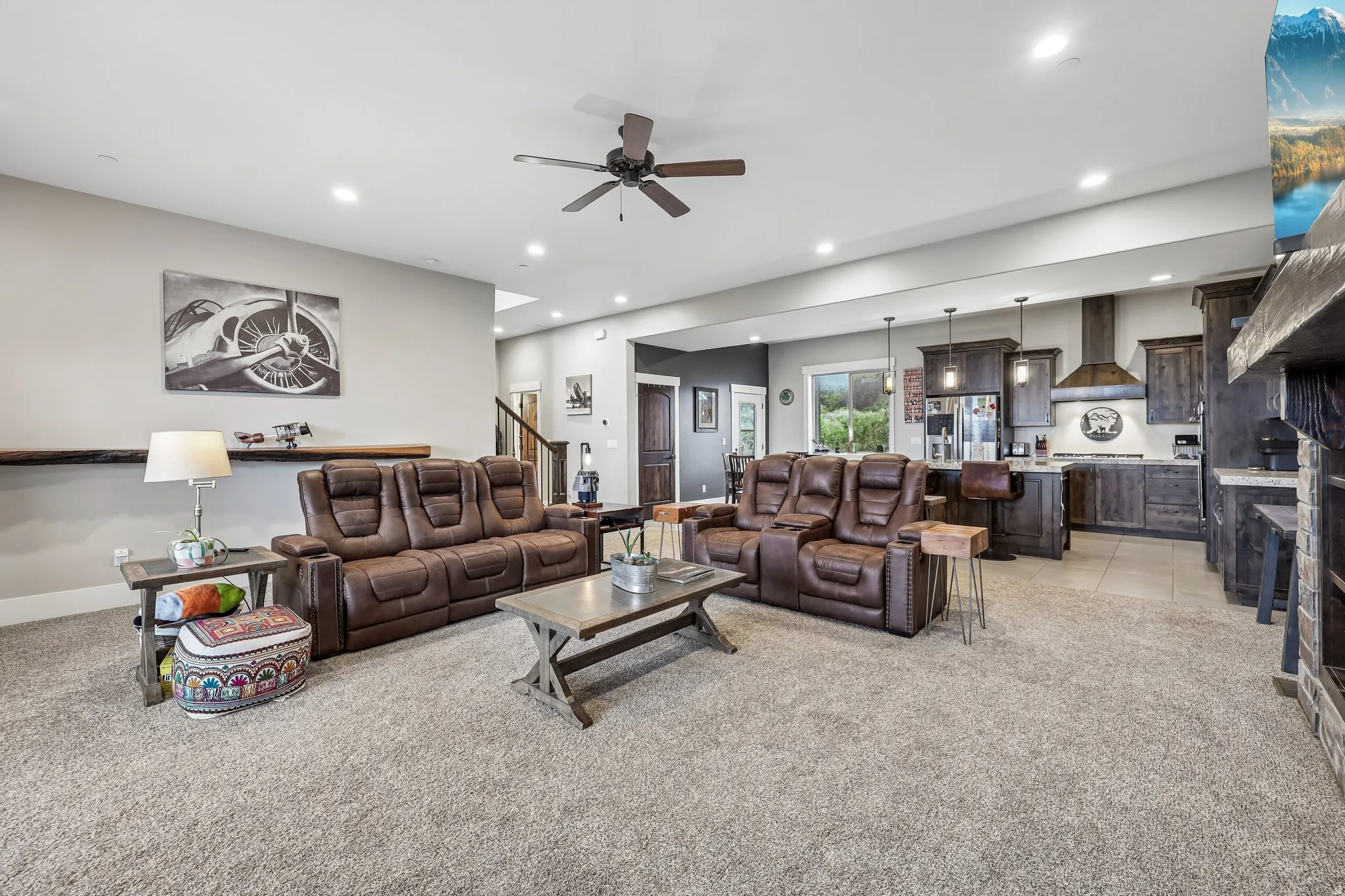 Open-concept main level with the living room, dining area and kitchen in one run, in a Rustler at Hideout home near Jordanelle Reservoir.