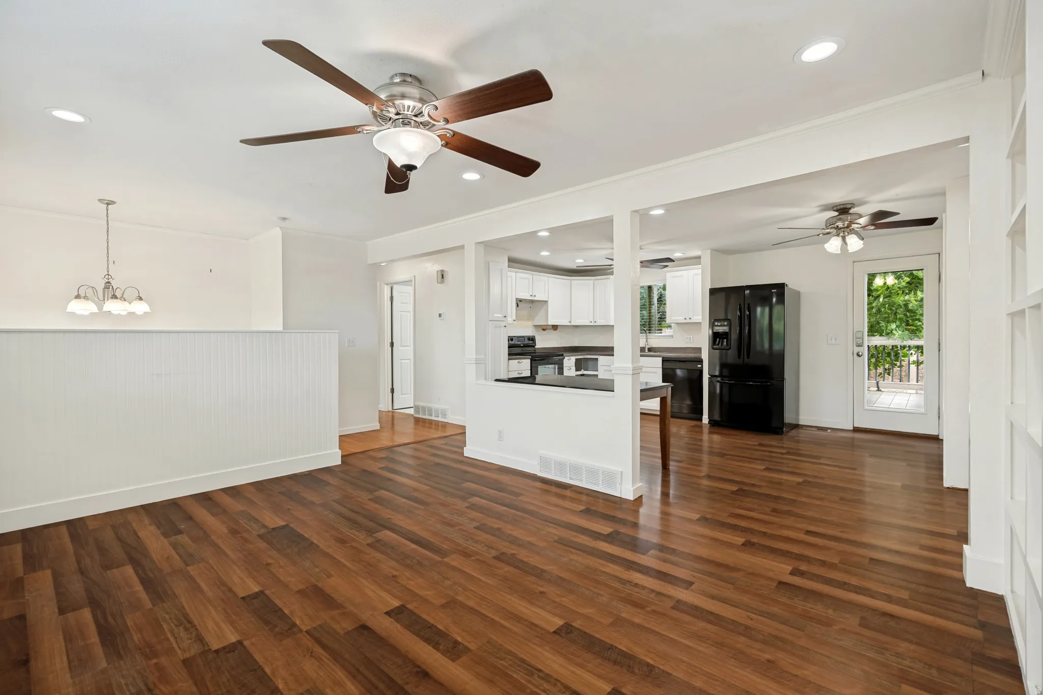 Bright and open floor-plan. Wood-finish flooring throughout, with recessed lighting and ceiling fans