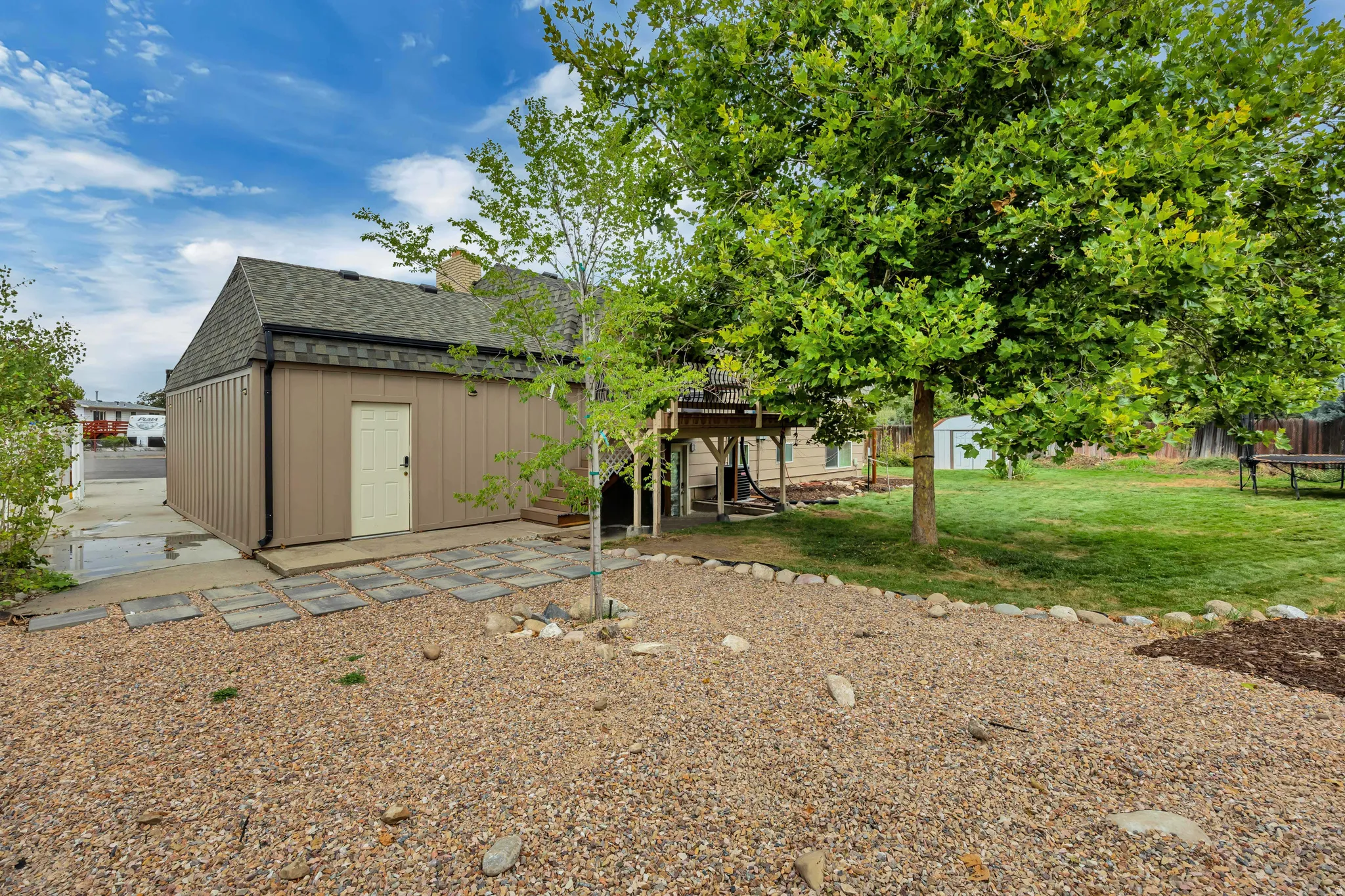Expansive potential garden area, mature trees, lawn, elevated deck, stone stepping path