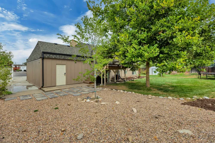 Expansive potential garden area, mature trees, lawn, elevated deck, stone stepping path