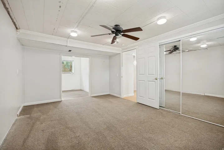 Soft carpet flooring, paneled ceiling, recessed lighting, ceiling fan, and mirrored closet doors