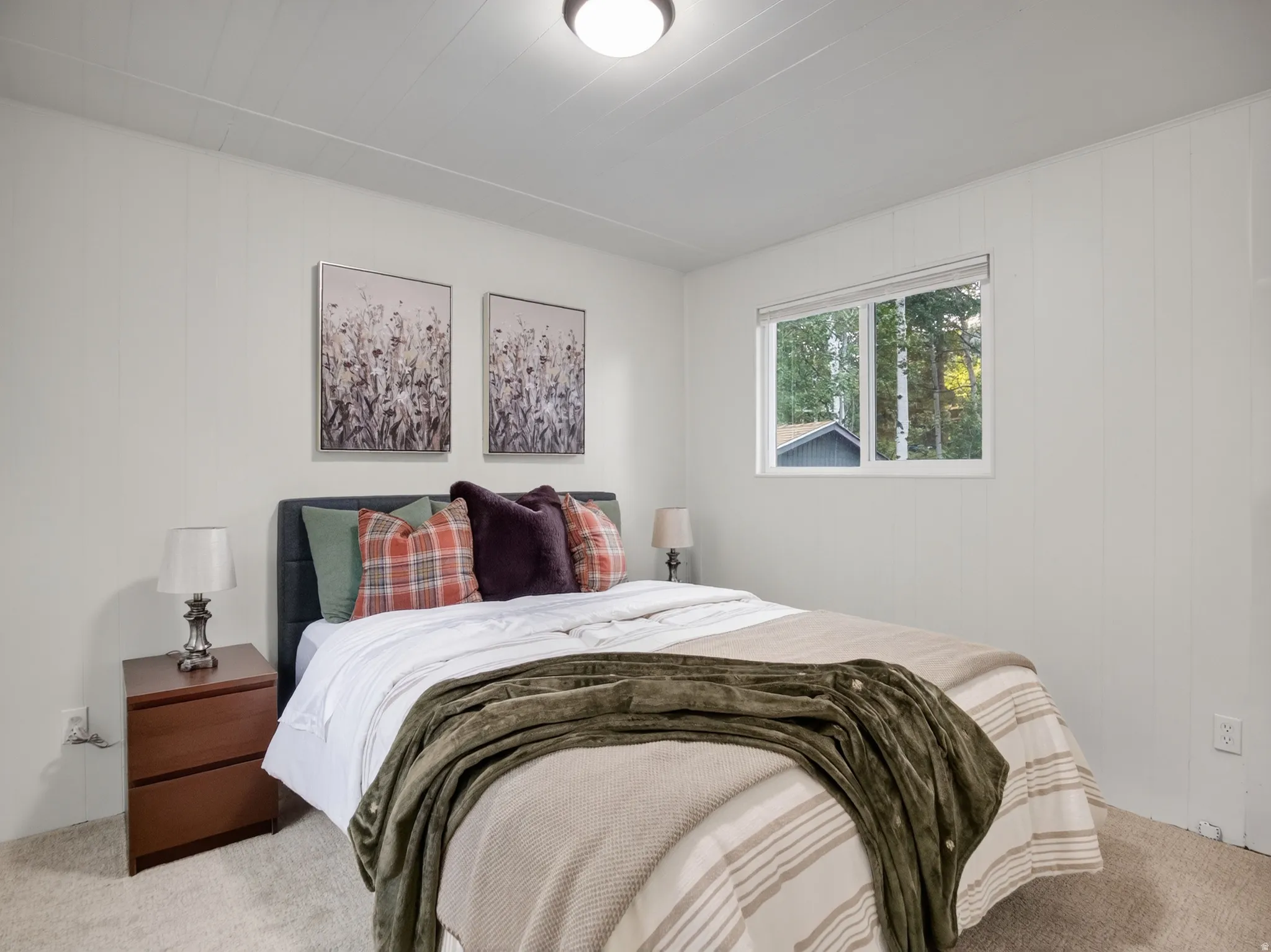 Window with outdoor scenery, light-colored walls, recessed ceiling lighting