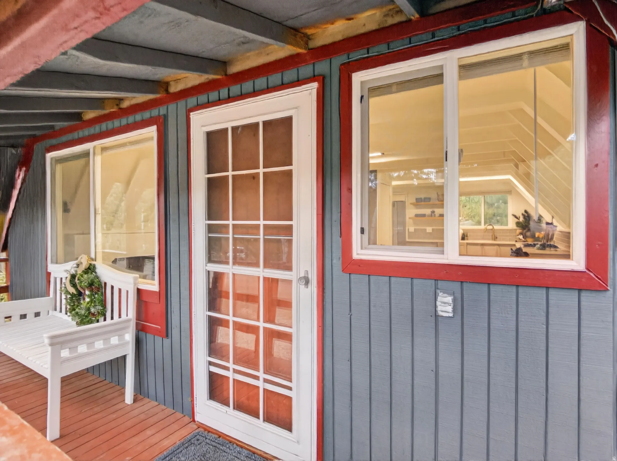 Vertical siding exterior with contrasting trim, covered porch, and white-framed windows