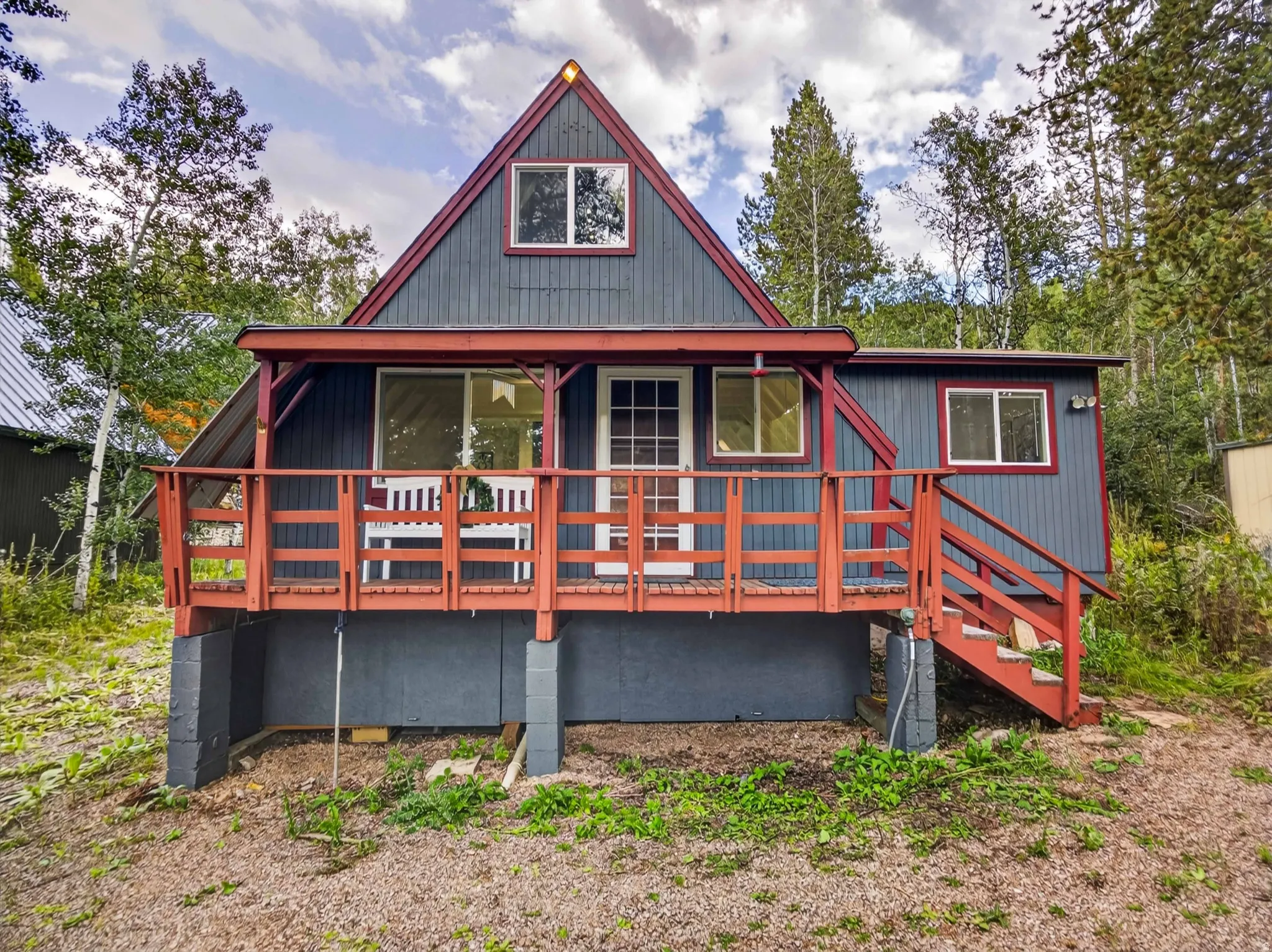 A-frame architecture featuring dark siding and contrasting trim