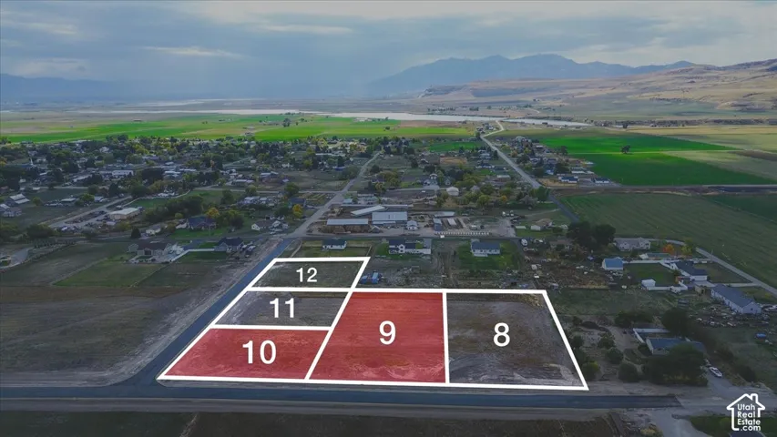 Aerial perspective of vacant land parcels featuring expansive mountain scenery and rural surroundings