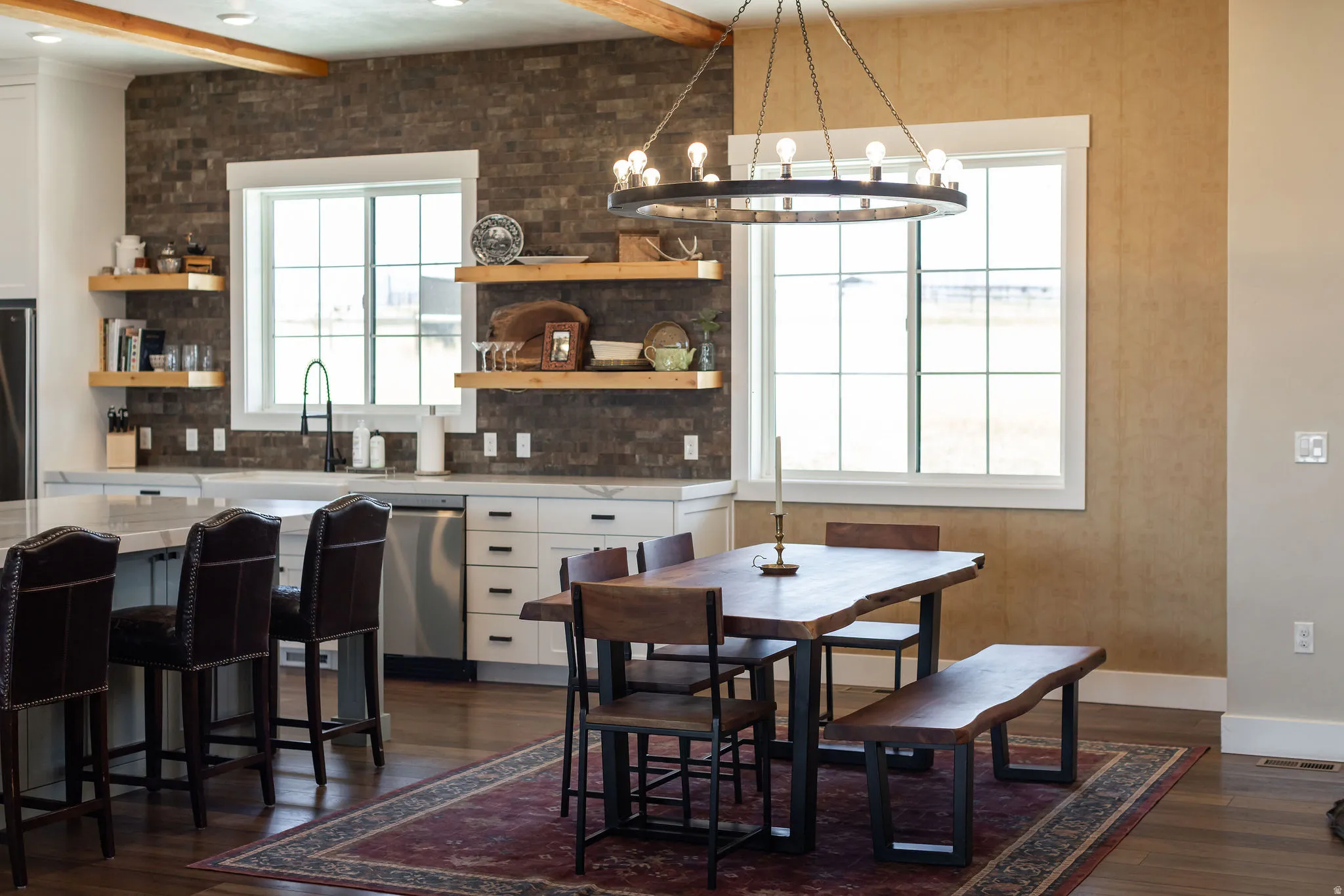 Kitchen featuring white cabinetry, stone tile backsplash, and floating wood shelves