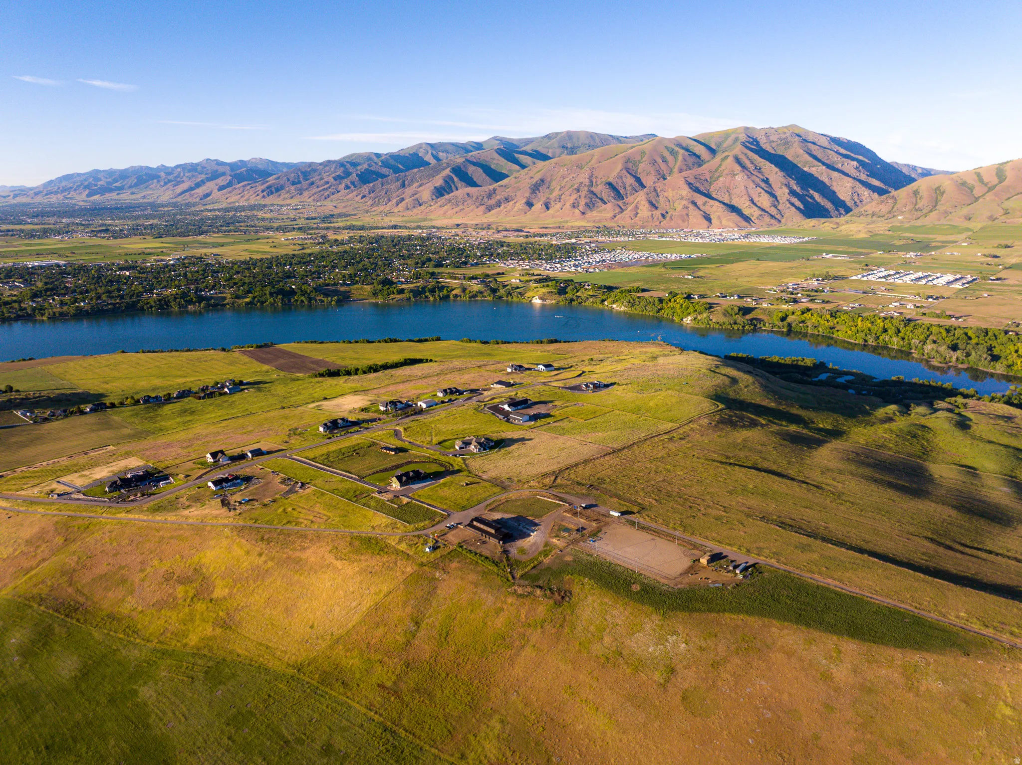 Expansive land parcel featuring multiple structures, surrounded by natural terrain