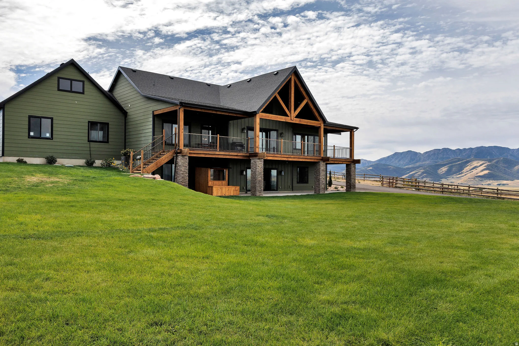 Modern farmhouse exterior with green siding and black trim