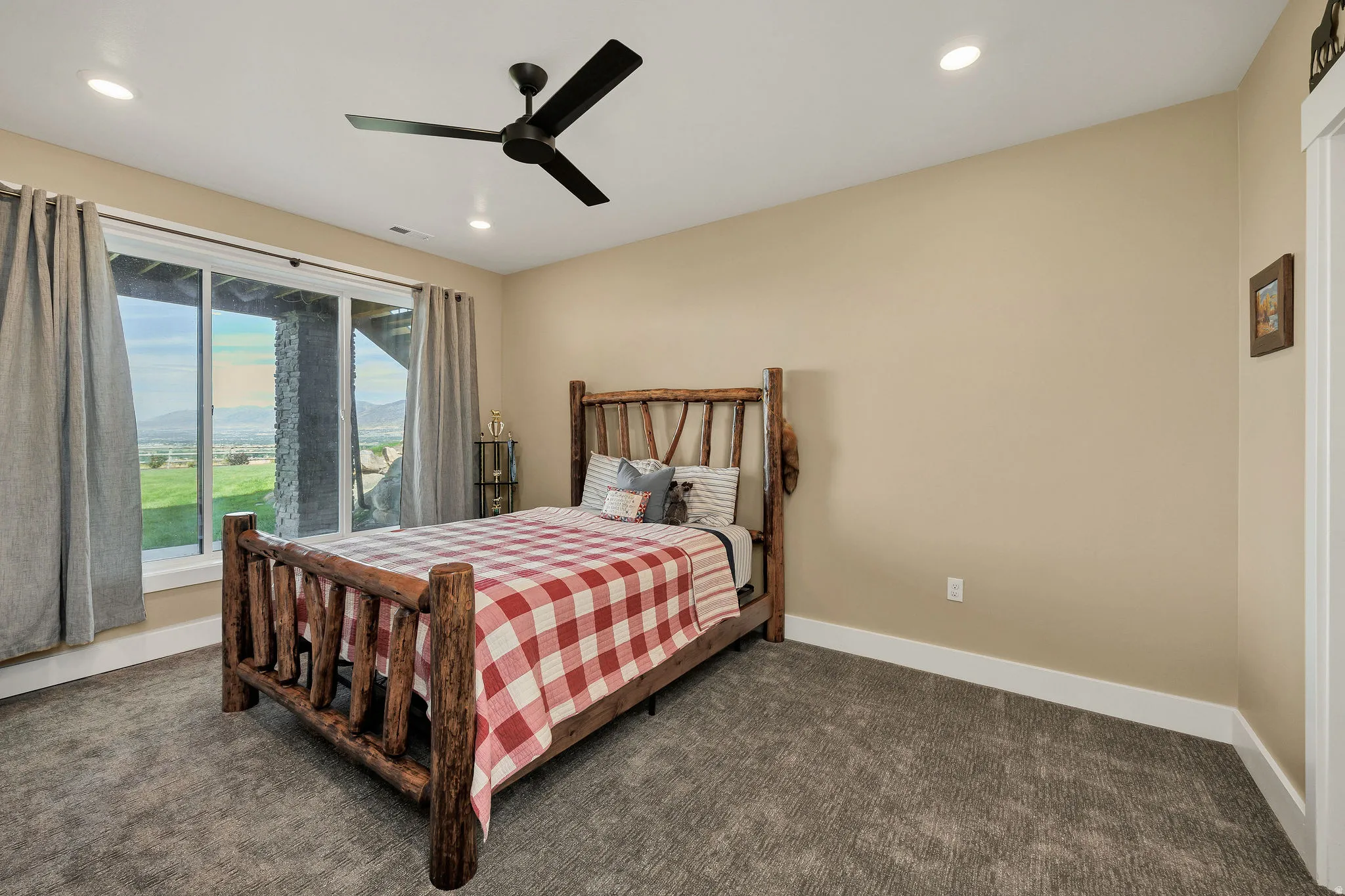 Sliding glass door, recessed lighting, ceiling fan, and carpeted flooring