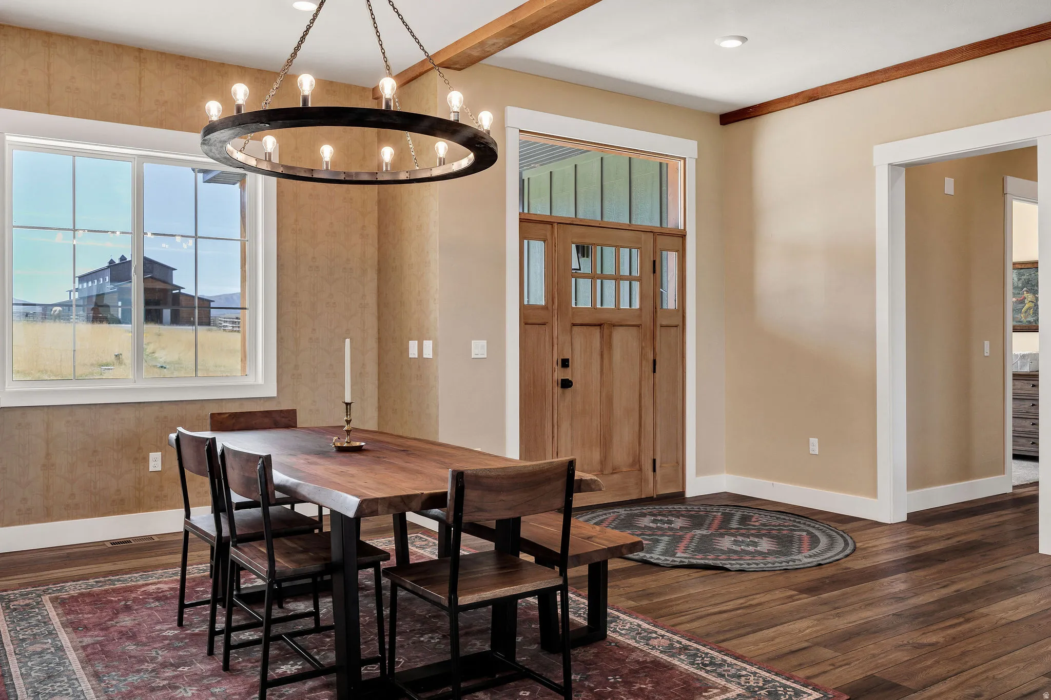 Wood-finish flooring throughout, featuring a natural wood entry door with glass panels