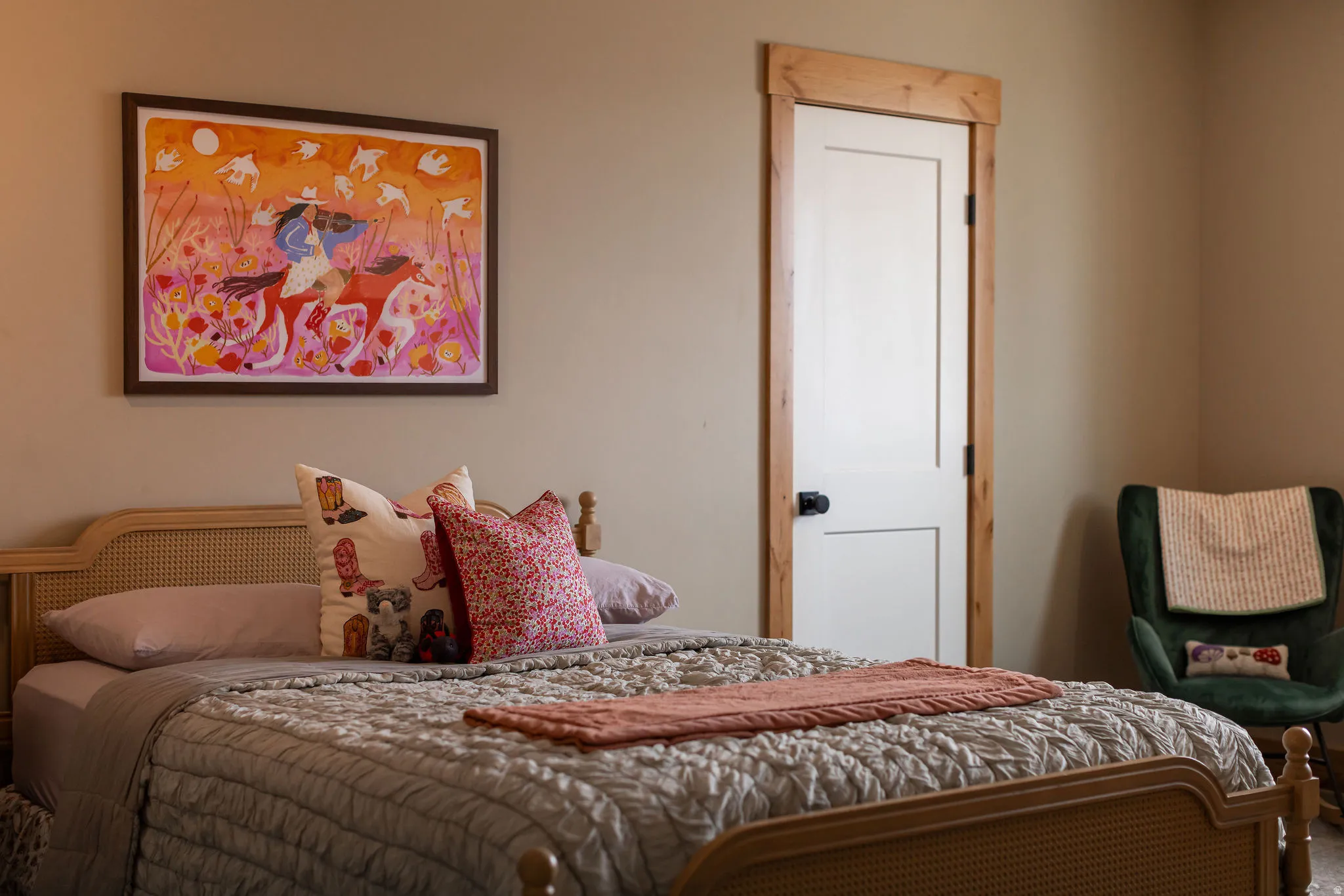 White interior door with wood trim, neutral wall color