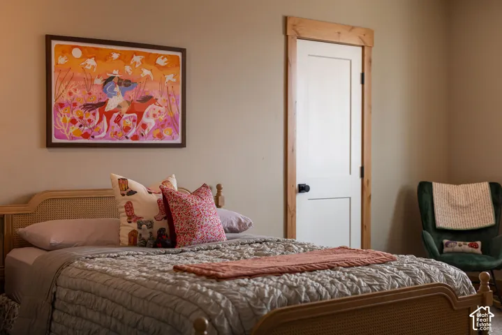 White interior door with wood trim, neutral wall color