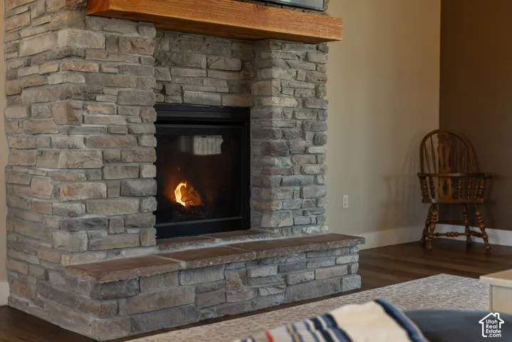 Stone-clad fireplace with a hearth and a substantial wood mantel