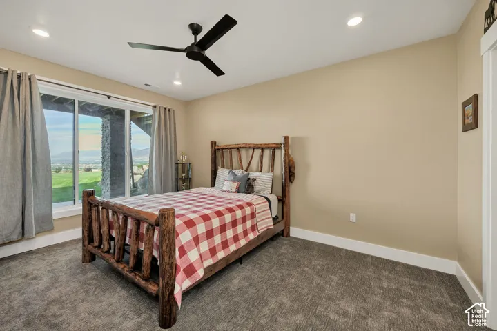 Sliding glass door, recessed lighting, ceiling fan, and carpeted flooring