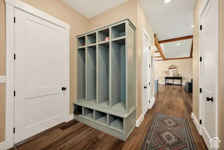 Built-in storage cubbies, wood-finish flooring, exposed ceiling beams, and recessed lighting