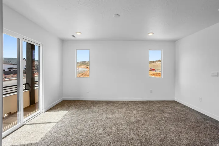 Wall-to-wall carpeting with white baseboards and recessed lighting