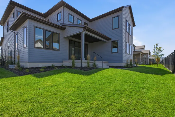 Expansive lawn area with a black metal fence