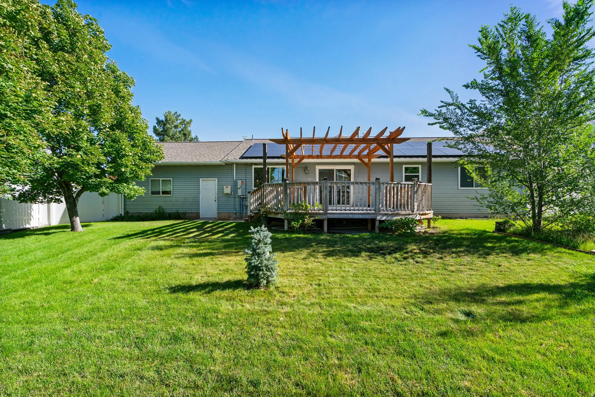 Expansive green lawn with mature trees