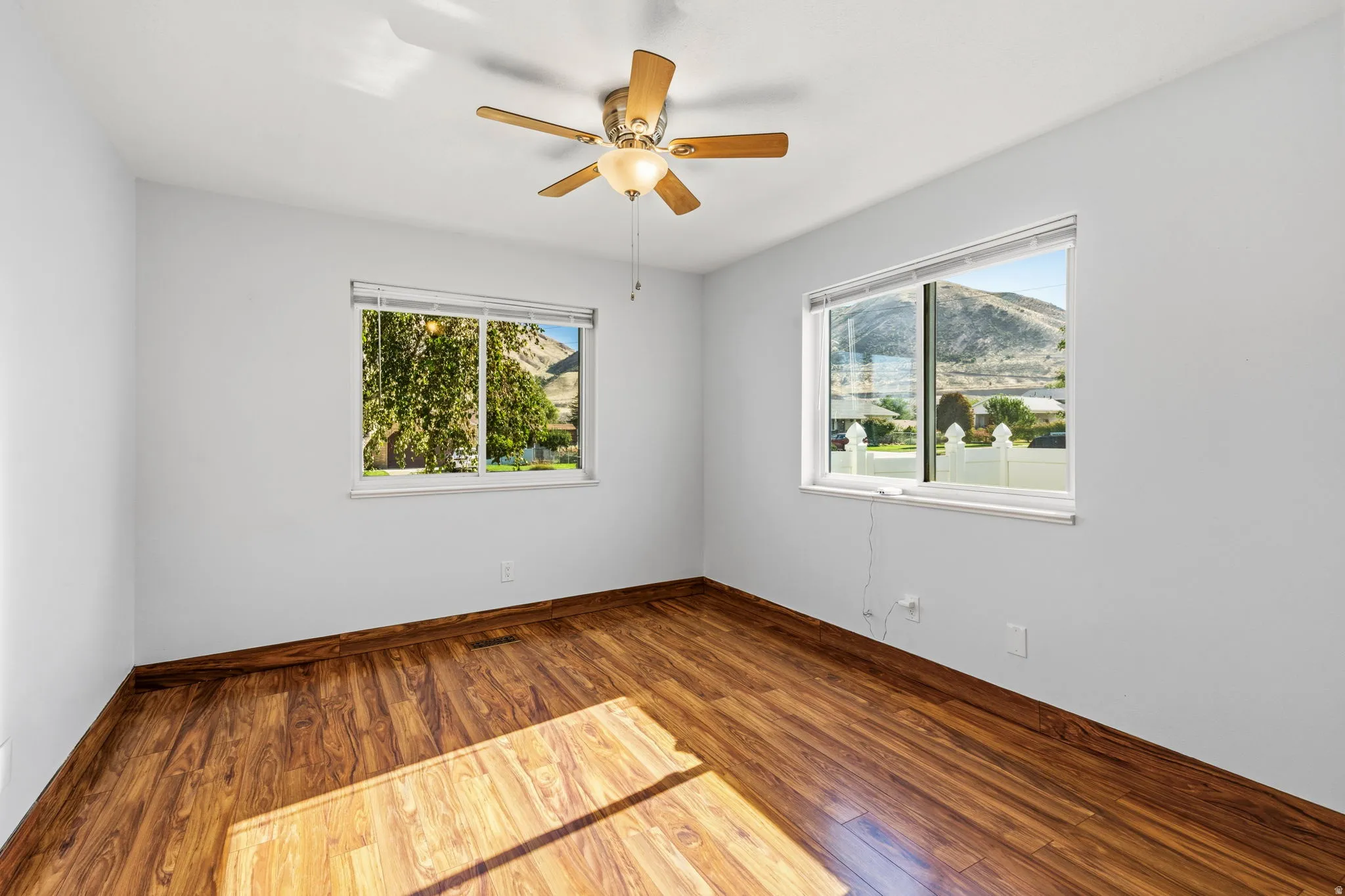 Wood-finish flooring with a ceiling fan light fixture