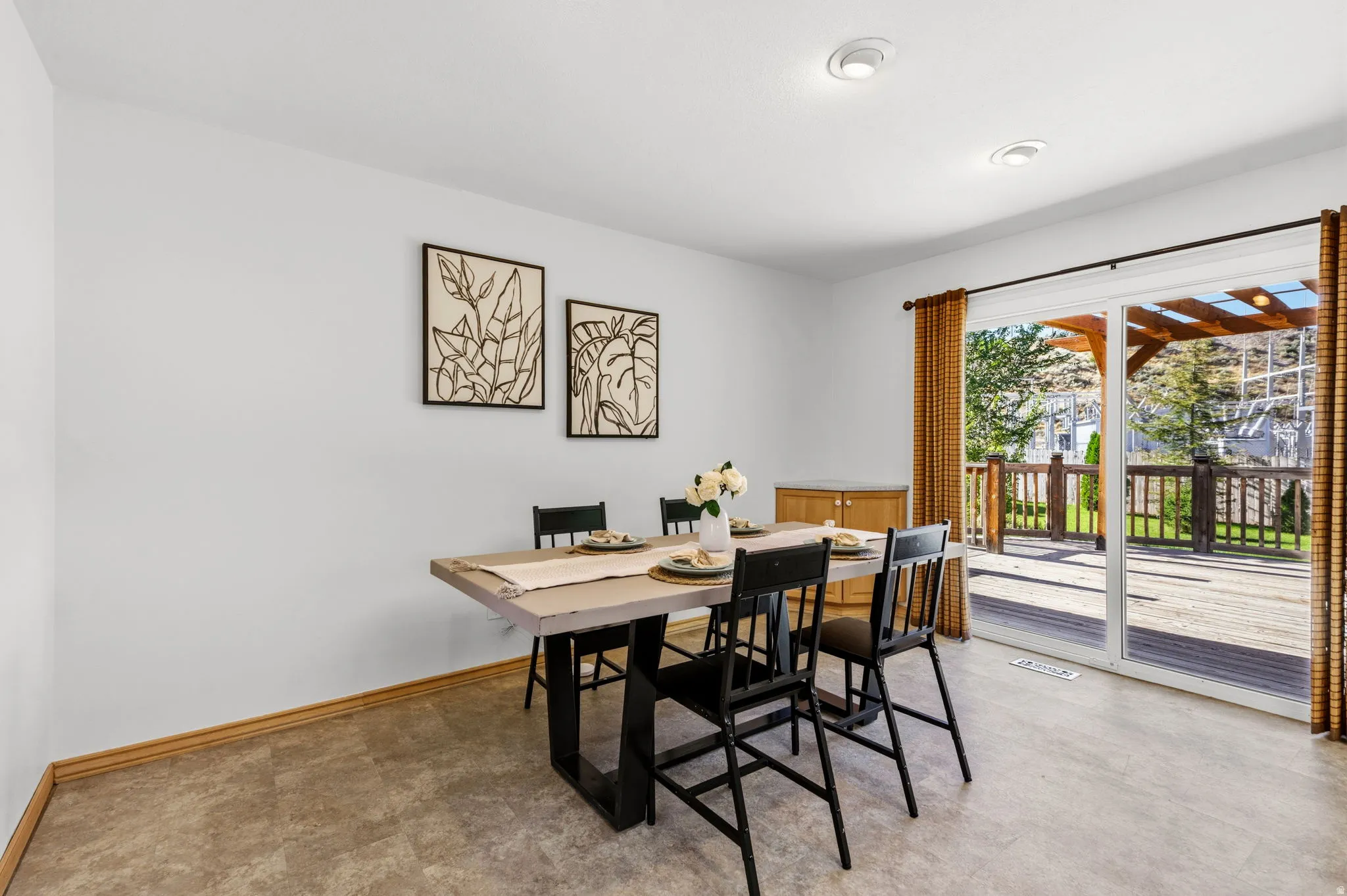 Recessed ceiling lighting, durable flooring, sliding glass door, and a spacious outdoor deck with a wooden pergola
