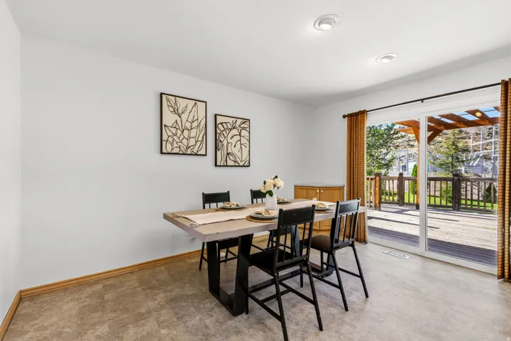 Recessed ceiling lighting, durable flooring, sliding glass door, and a spacious outdoor deck with a wooden pergola