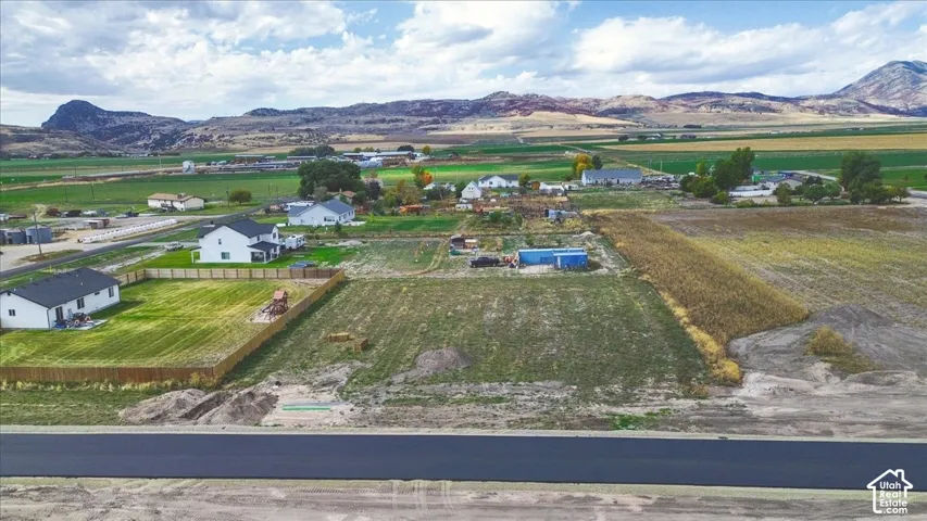 Expansive acreage featuring paved road frontage, natural topography, and mountain backdrops