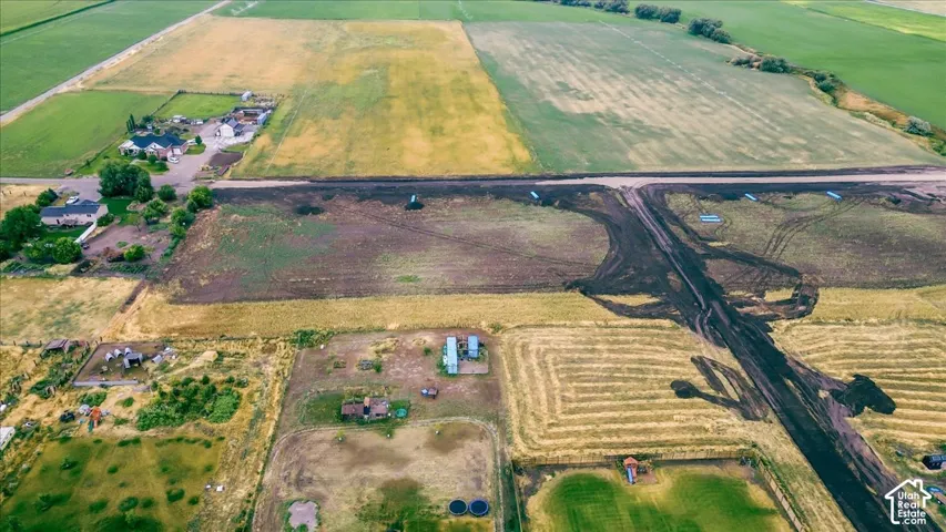 Expansive agricultural land featuring cultivated fields and undeveloped parcels