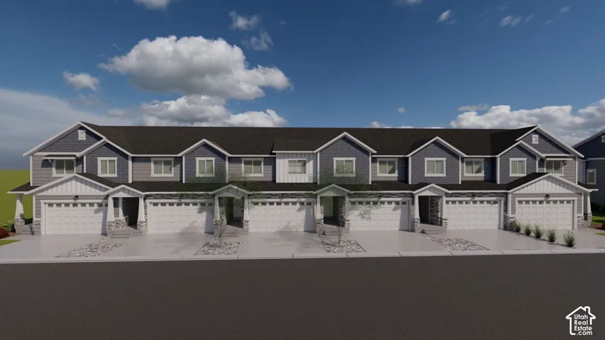 Modern townhome facade featuring a two-car garage, stone accents, and a shingled roof