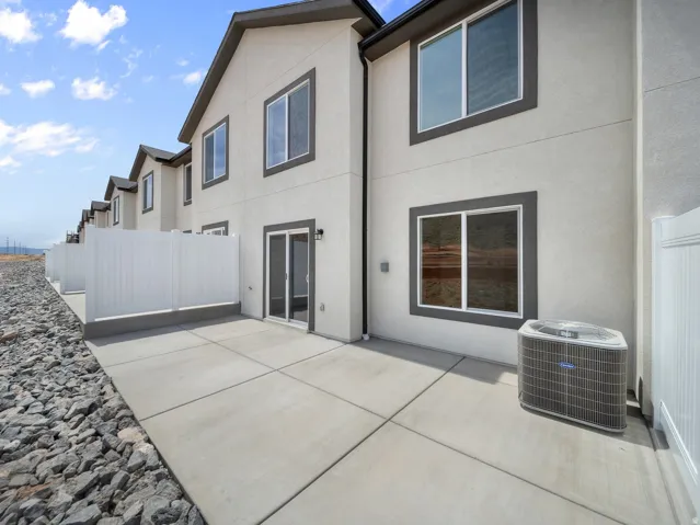 Private patio with concrete pavers and perimeter fencing