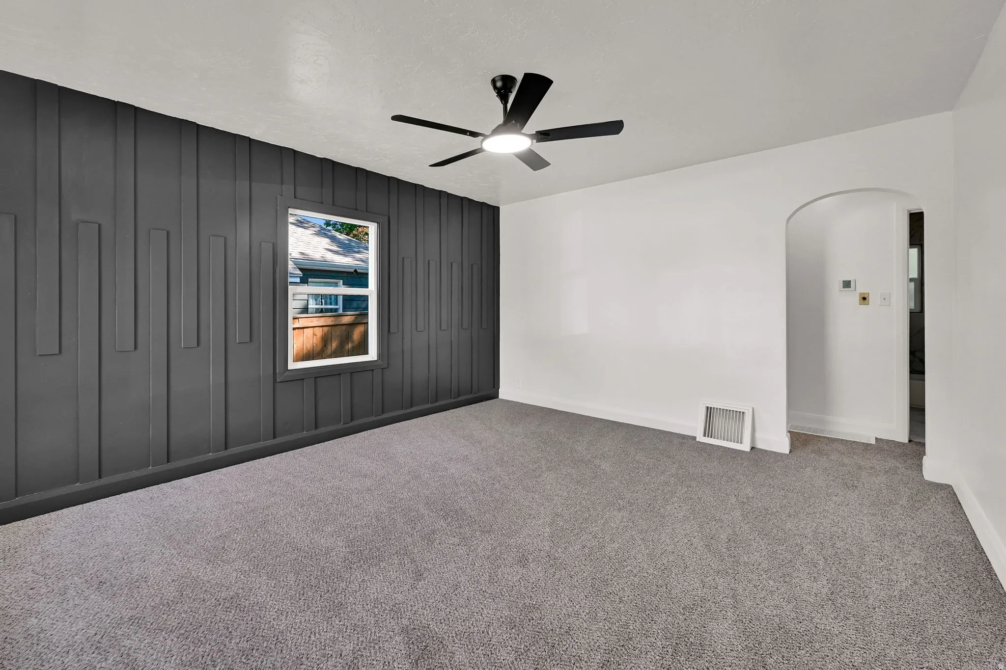 Accent wall featuring decorative vertical paneling