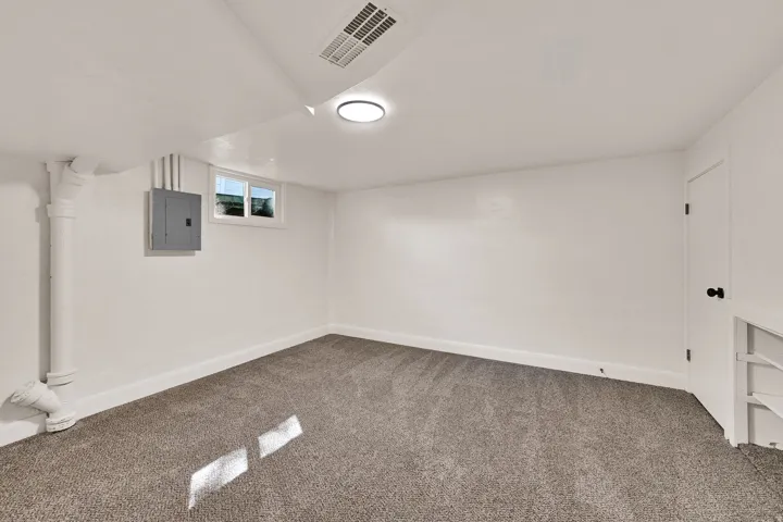 Gray carpeted flooring with white painted walls