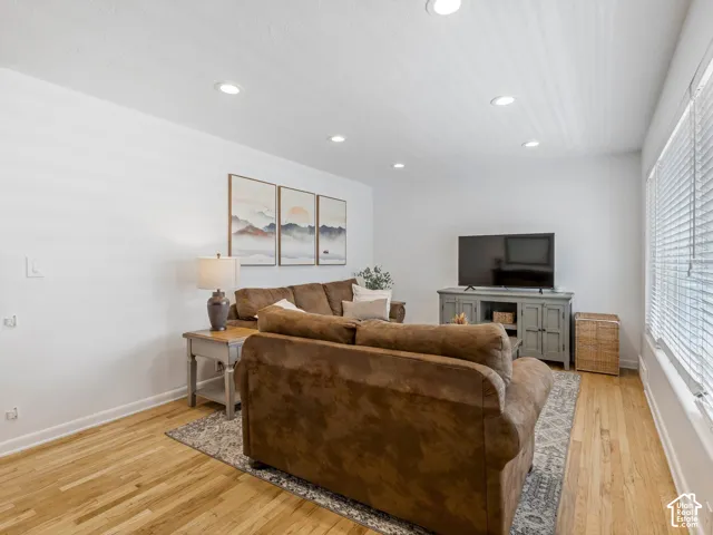 Natural light living room with hardwood floors.