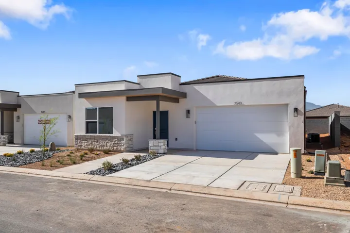Modern stucco exterior with stone accents and a covered entry