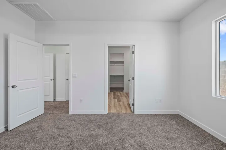 Soft gray carpeting and white walls
