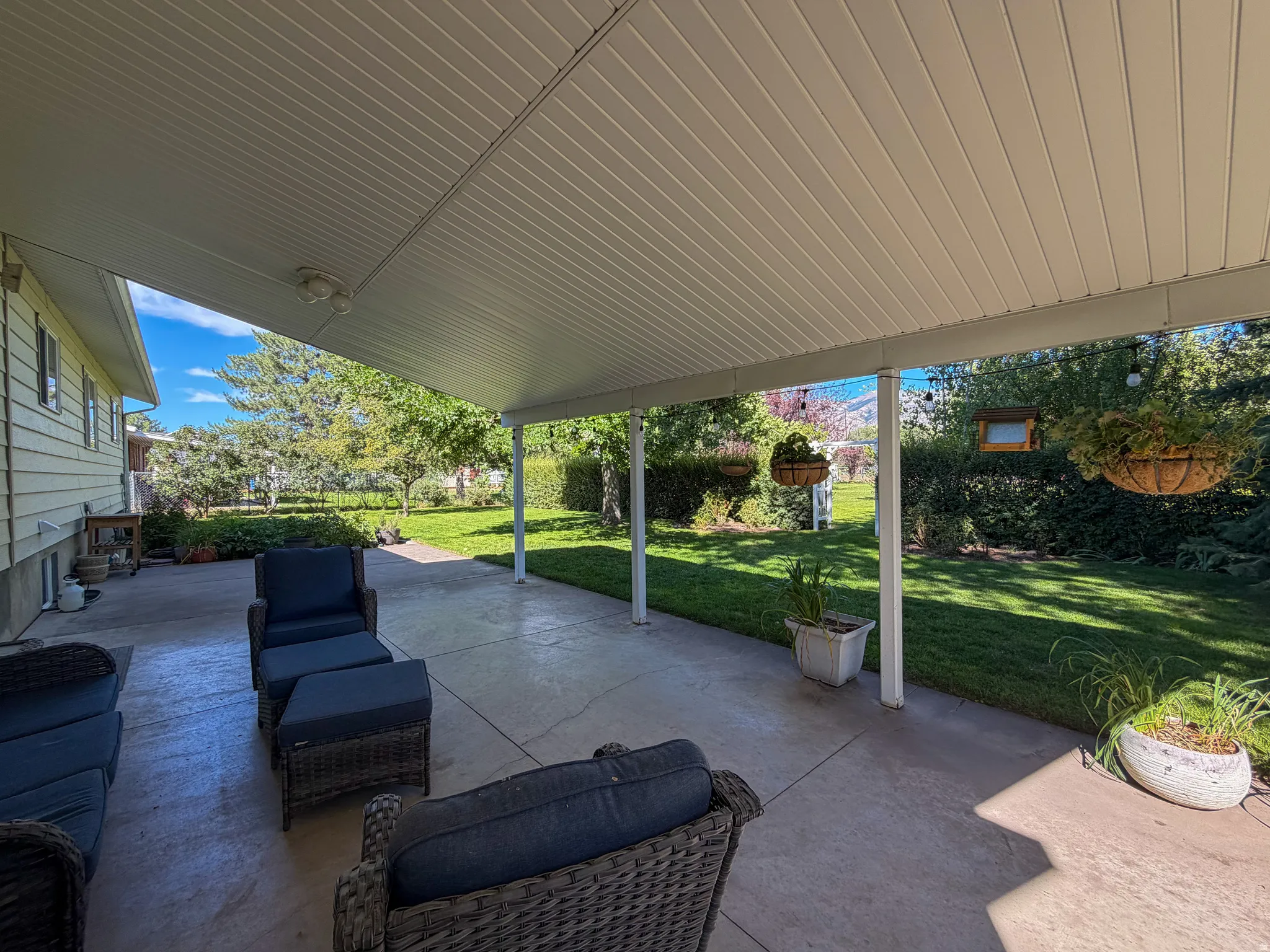 peaceful and private backyard with patio and covered awning