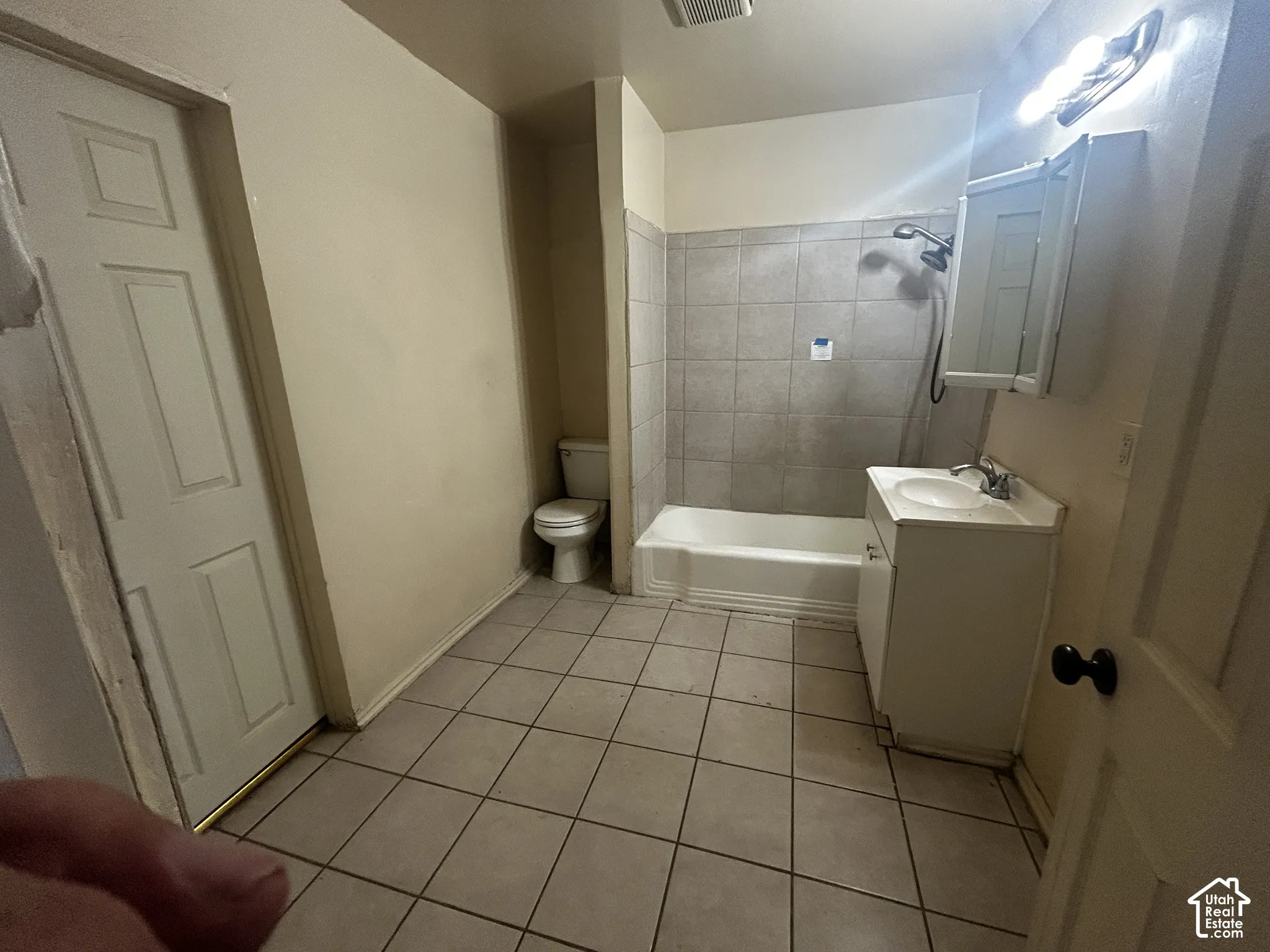 Tile flooring with a single vanity, integrated sink, and medicine cabinet