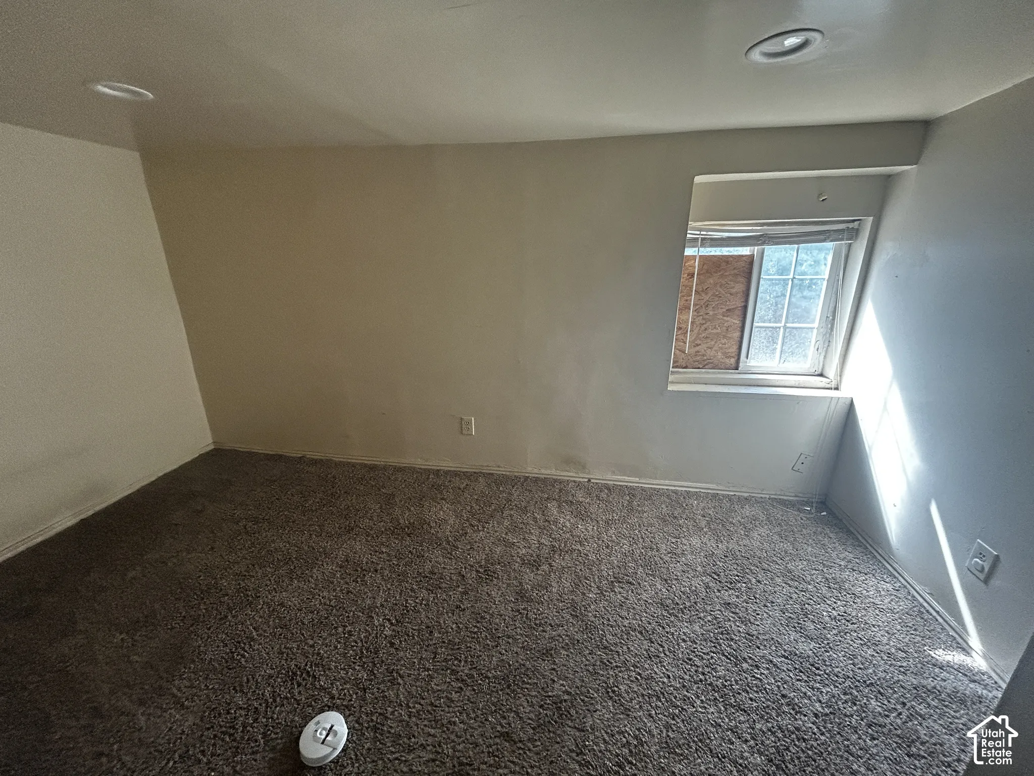 Recessed lighting fixtures, broadloom carpet, and a window opening