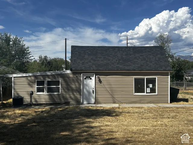 Single-story residence featuring horizontal siding and a dark shingle roof