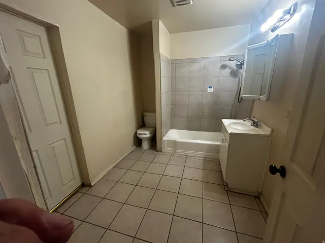Tile flooring with a single vanity, integrated sink, and medicine cabinet