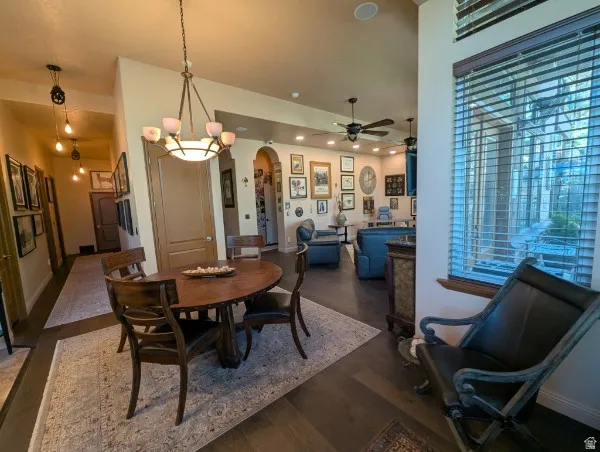 Wood-finish flooring throughout, modern ceiling fans, recessed lighting, and a decorative archway