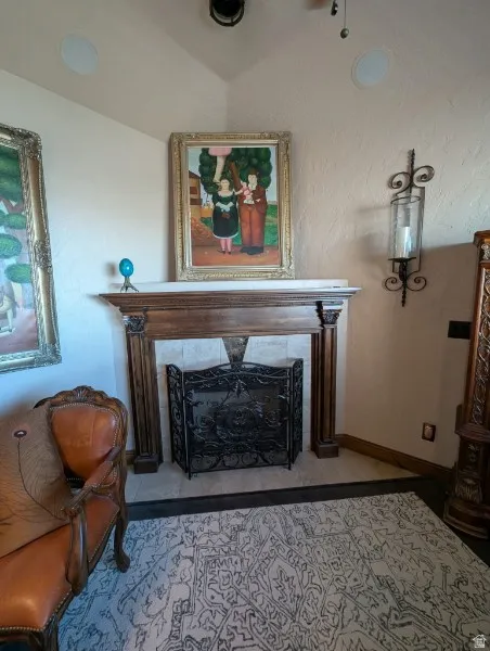 Primary bedroom fireplace with wood mantel and surround, tile hearth, and an ornate iron screen