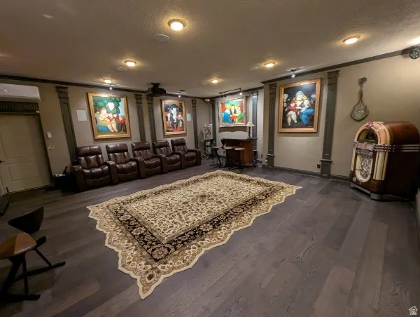 Theatre room with dark wood-finish flooring with recessed lighting