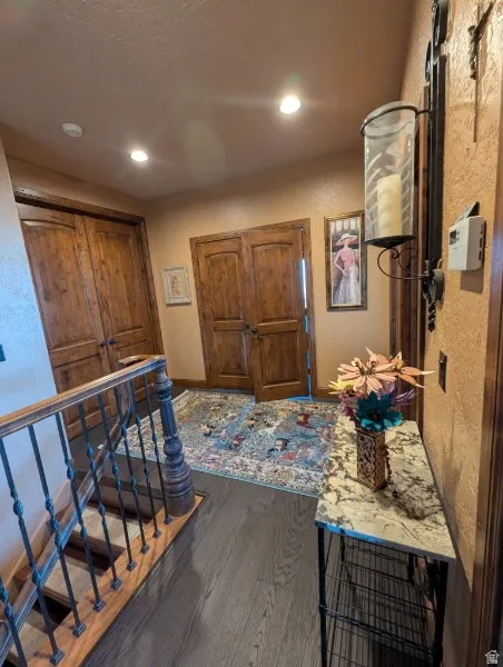 Dark wood-finish flooring with recessed lighting