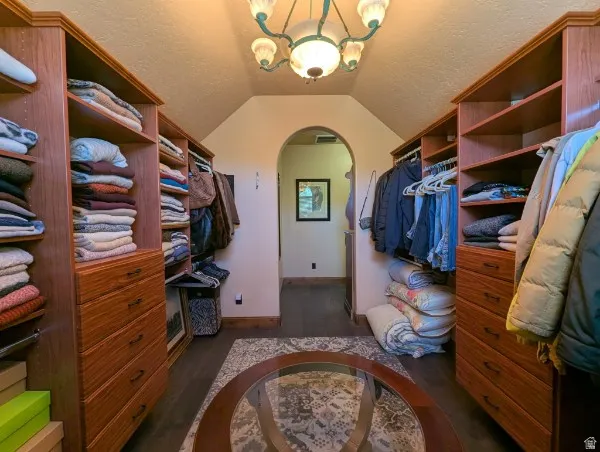 Primary bedroon colset with built-in wood shelving and drawers provide organization
