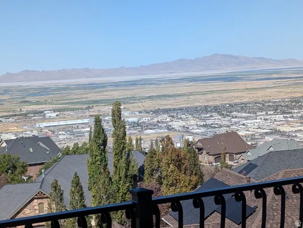 Expansive valley scenery featuring distant mountains and a cityscape