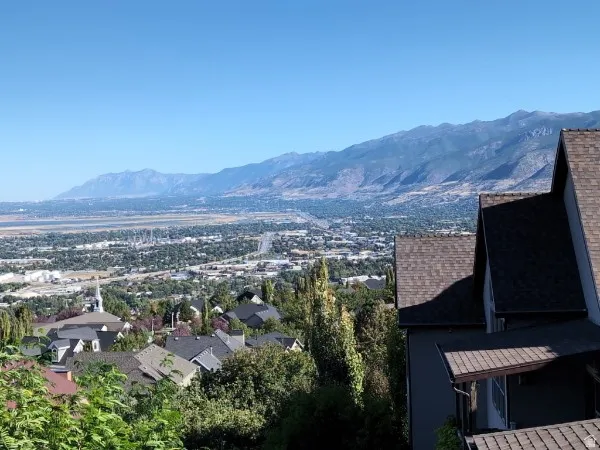 Mountain backdrop with residential area and distant urban features